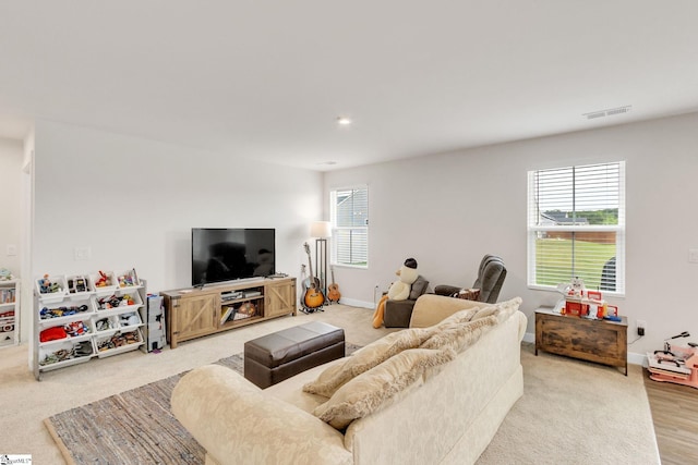 living room featuring plenty of natural light and light carpet