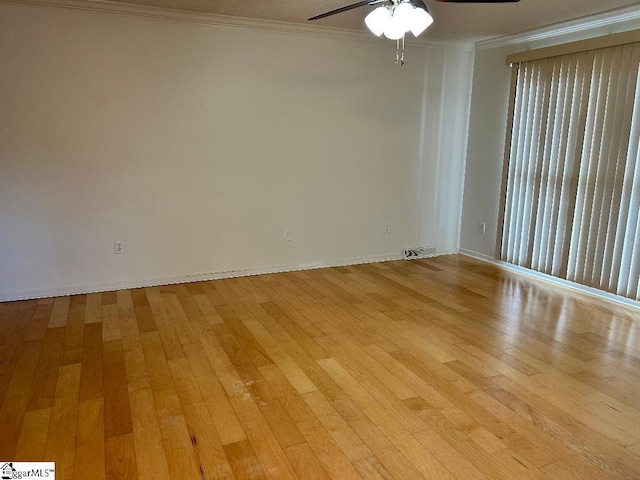 spare room featuring ornamental molding, ceiling fan, and light hardwood / wood-style floors