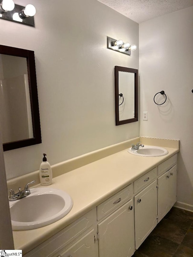 bathroom with vanity and a textured ceiling