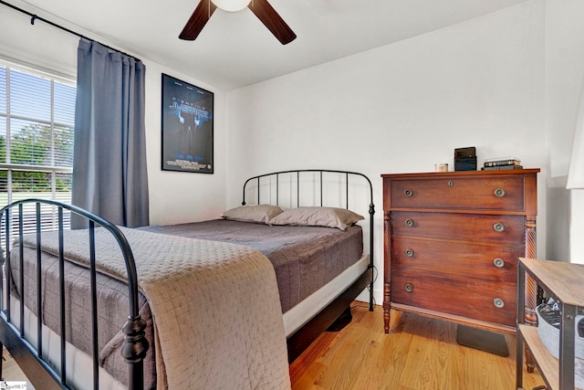 bedroom with light hardwood / wood-style floors and ceiling fan