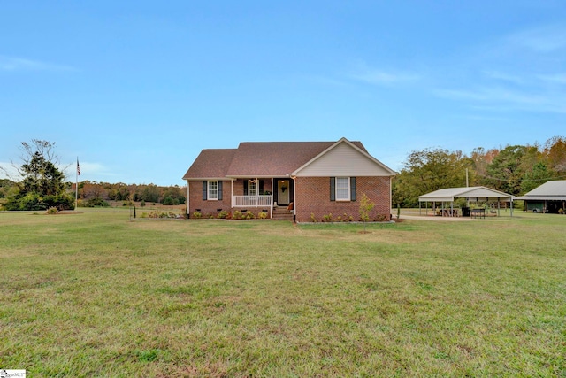 ranch-style home with covered porch and a front yard