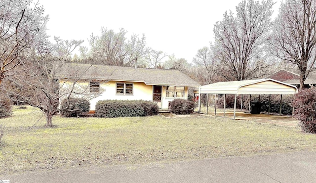 single story home featuring a carport and a front lawn