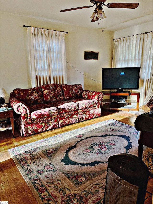 living room with hardwood / wood-style flooring and ceiling fan