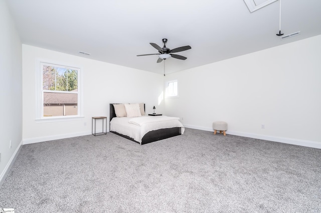 unfurnished bedroom featuring multiple windows, carpet floors, and ceiling fan