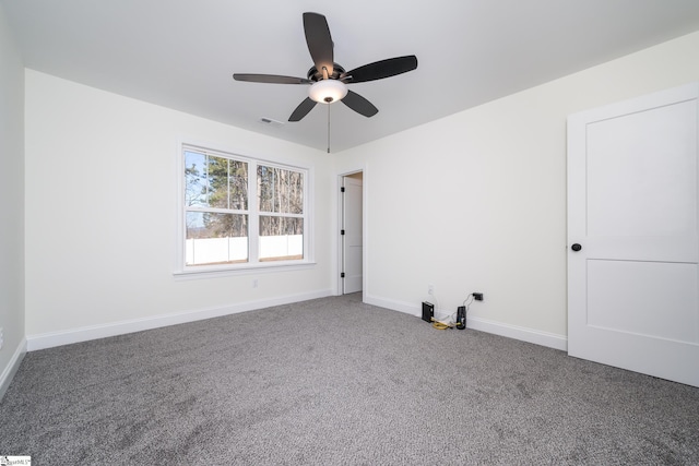 empty room with ceiling fan and carpet