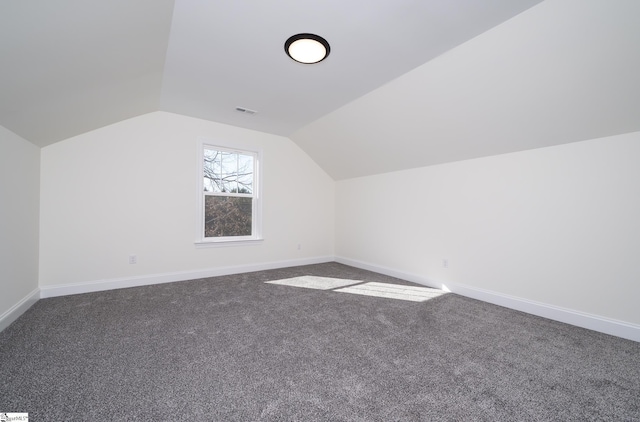 bonus room with lofted ceiling and carpet