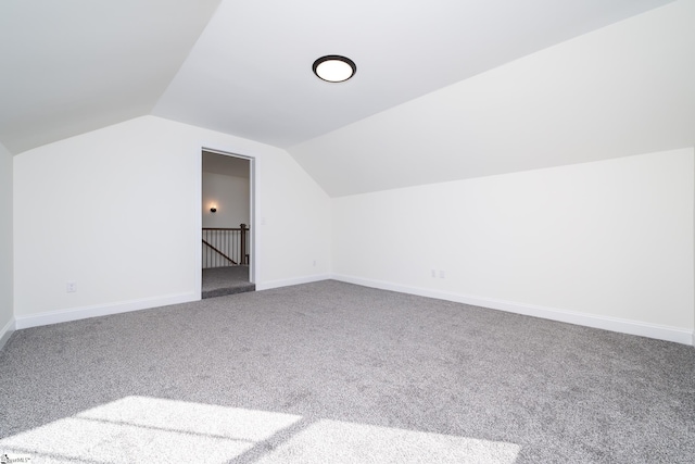 additional living space with lofted ceiling and carpet floors