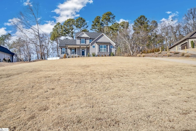 view of front facade with covered porch and a front lawn