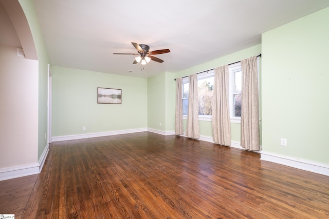 spare room featuring ceiling fan and dark hardwood / wood-style floors