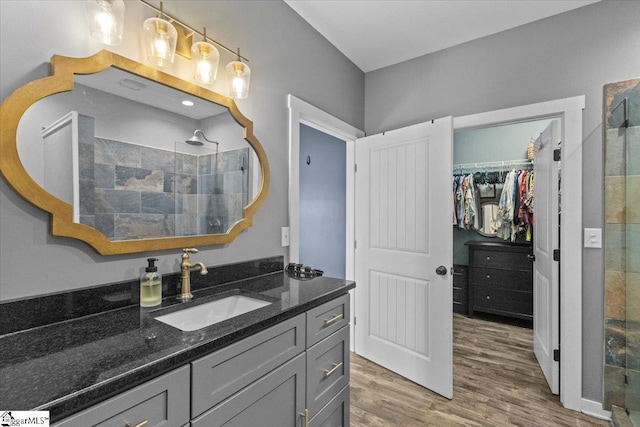 bathroom with vanity, hardwood / wood-style floors, and a shower