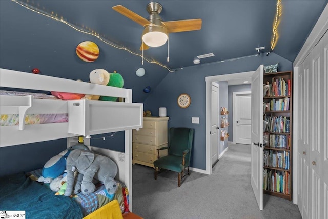 bedroom featuring lofted ceiling, a closet, ceiling fan, and carpet