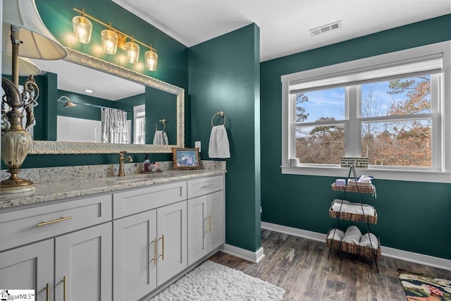 bathroom with hardwood / wood-style flooring, vanity, and a shower with curtain