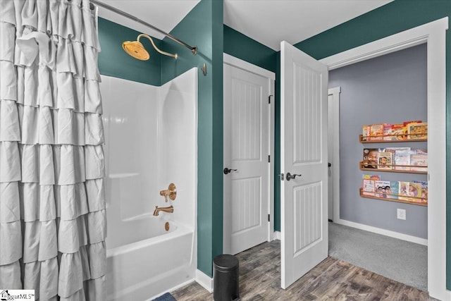 bathroom with bathtub / shower combination and hardwood / wood-style floors