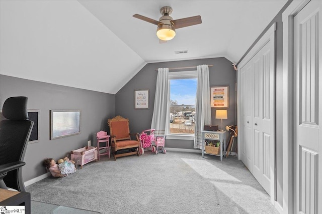 rec room with ceiling fan, lofted ceiling, and light carpet