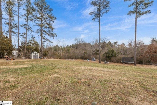 view of yard with a storage unit and a trampoline