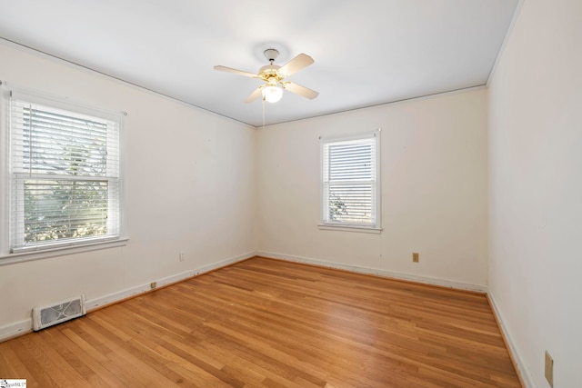 spare room featuring ceiling fan and light hardwood / wood-style flooring