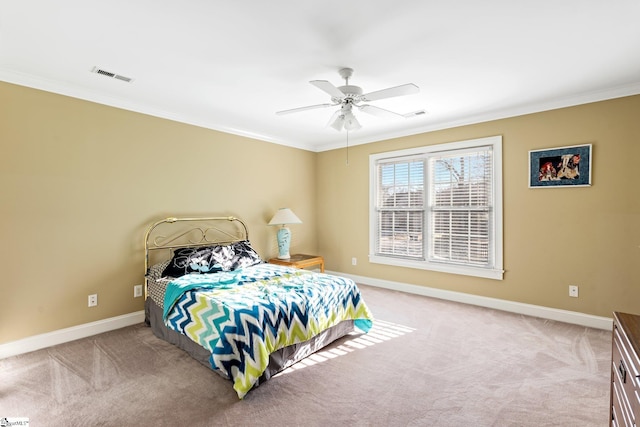 bedroom featuring crown molding, ceiling fan, and light carpet