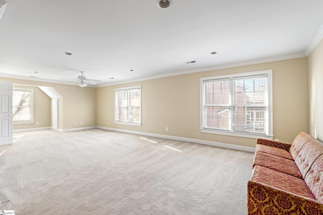 carpeted living room with crown molding, ceiling fan, and a wealth of natural light