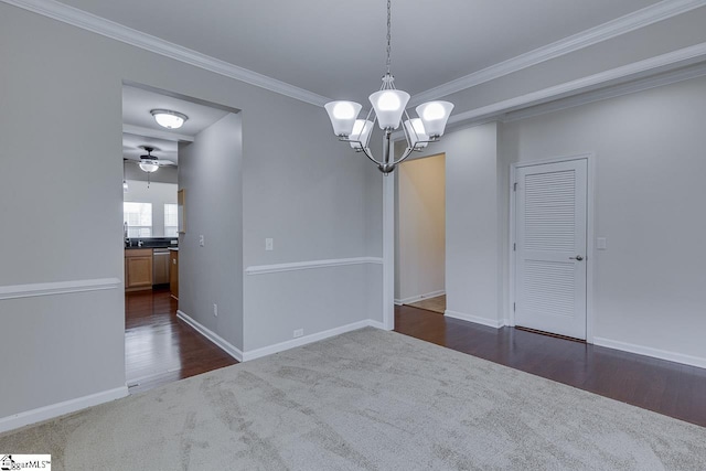 carpeted empty room featuring ceiling fan with notable chandelier and ornamental molding