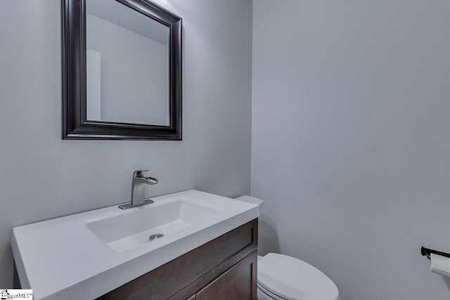 bathroom featuring vanity and toilet