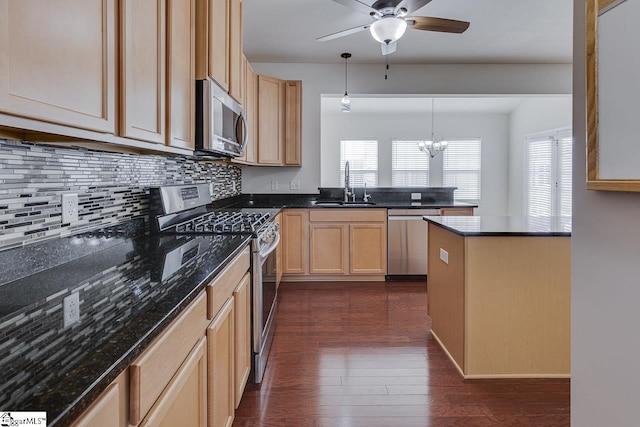 kitchen with sink, appliances with stainless steel finishes, dark hardwood / wood-style flooring, decorative light fixtures, and light brown cabinets