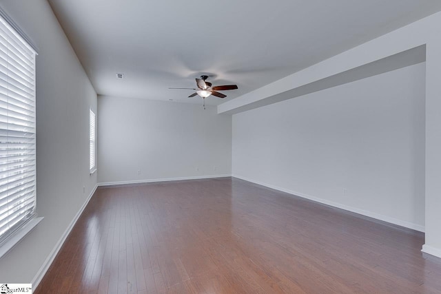 unfurnished room featuring ceiling fan and dark hardwood / wood-style floors