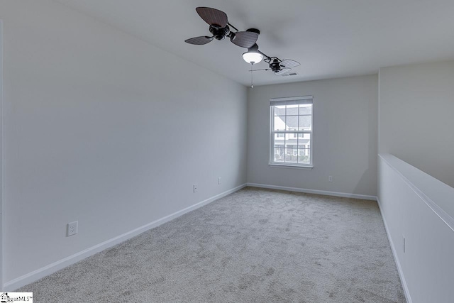 carpeted empty room featuring ceiling fan