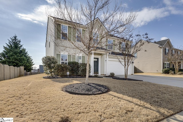 view of property with a garage and a front lawn