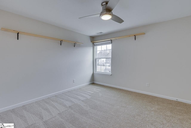 spare room featuring light carpet and ceiling fan