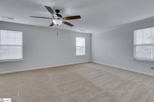 carpeted empty room featuring crown molding and ceiling fan