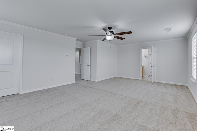 carpeted empty room featuring crown molding and ceiling fan