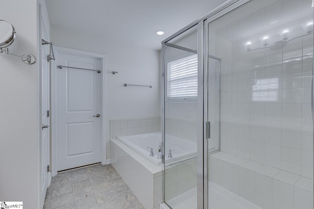 bathroom featuring independent shower and bath