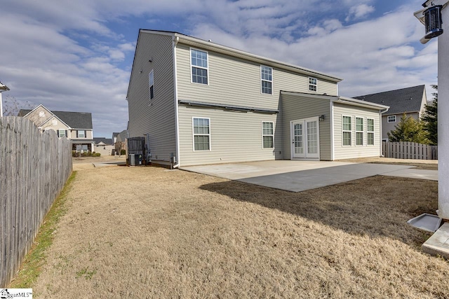 rear view of house featuring a patio area and a lawn