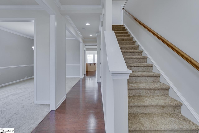 staircase with crown molding and carpet