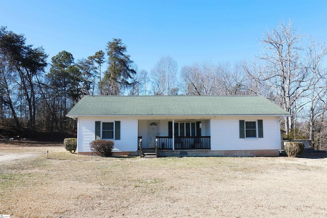 ranch-style house with a porch and a front lawn