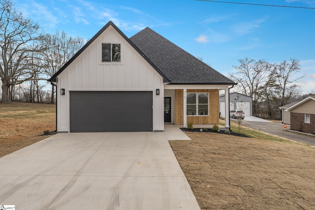 view of front of home with a garage and a front lawn