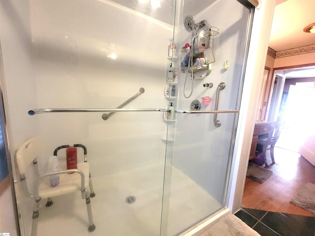 bathroom with an enclosed shower and wood-type flooring