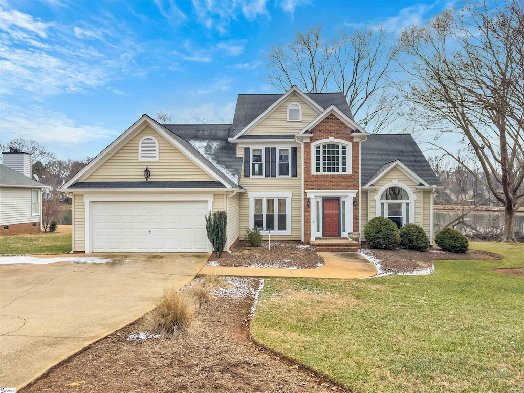 view of front of property with a garage and a front yard