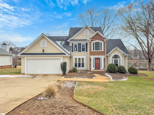 view of front of property with a garage and a front yard