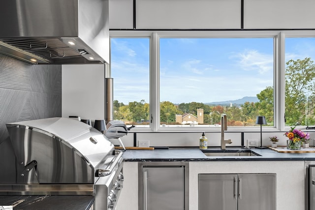 kitchen featuring sink, stainless steel fridge, wine cooler, island range hood, and a mountain view