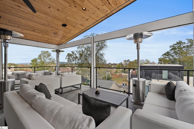 interior space with an outdoor hangout area and ceiling fan