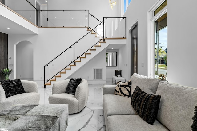 living room with plenty of natural light and a towering ceiling