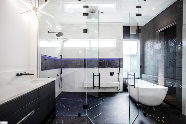 bathroom with vanity and independent shower and bath