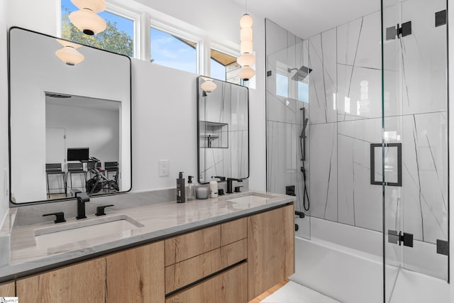 bathroom featuring vanity and bath / shower combo with glass door