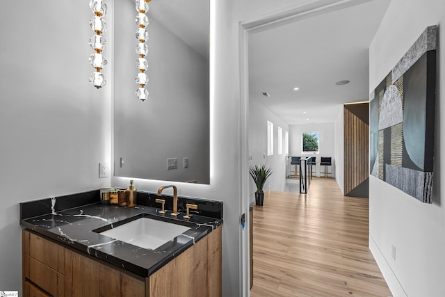 bathroom with hardwood / wood-style flooring and vanity