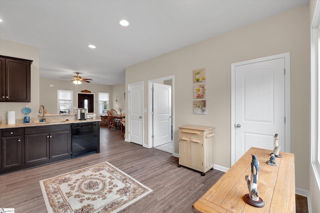 kitchen with sink, dark brown cabinets, light hardwood / wood-style flooring, dishwasher, and ceiling fan