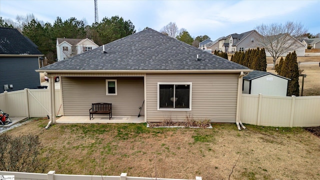 back of house featuring a lawn and a patio