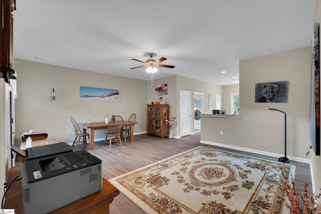 interior space with hardwood / wood-style flooring, ceiling fan, and washer / clothes dryer