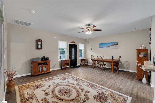 living room featuring hardwood / wood-style flooring and ceiling fan