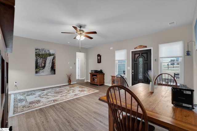 dining space featuring ceiling fan and light wood-type flooring